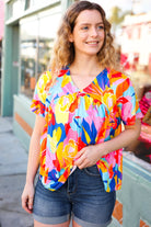 Orange & Yellow Geometric Floral V Neck Dolman Top Haptics